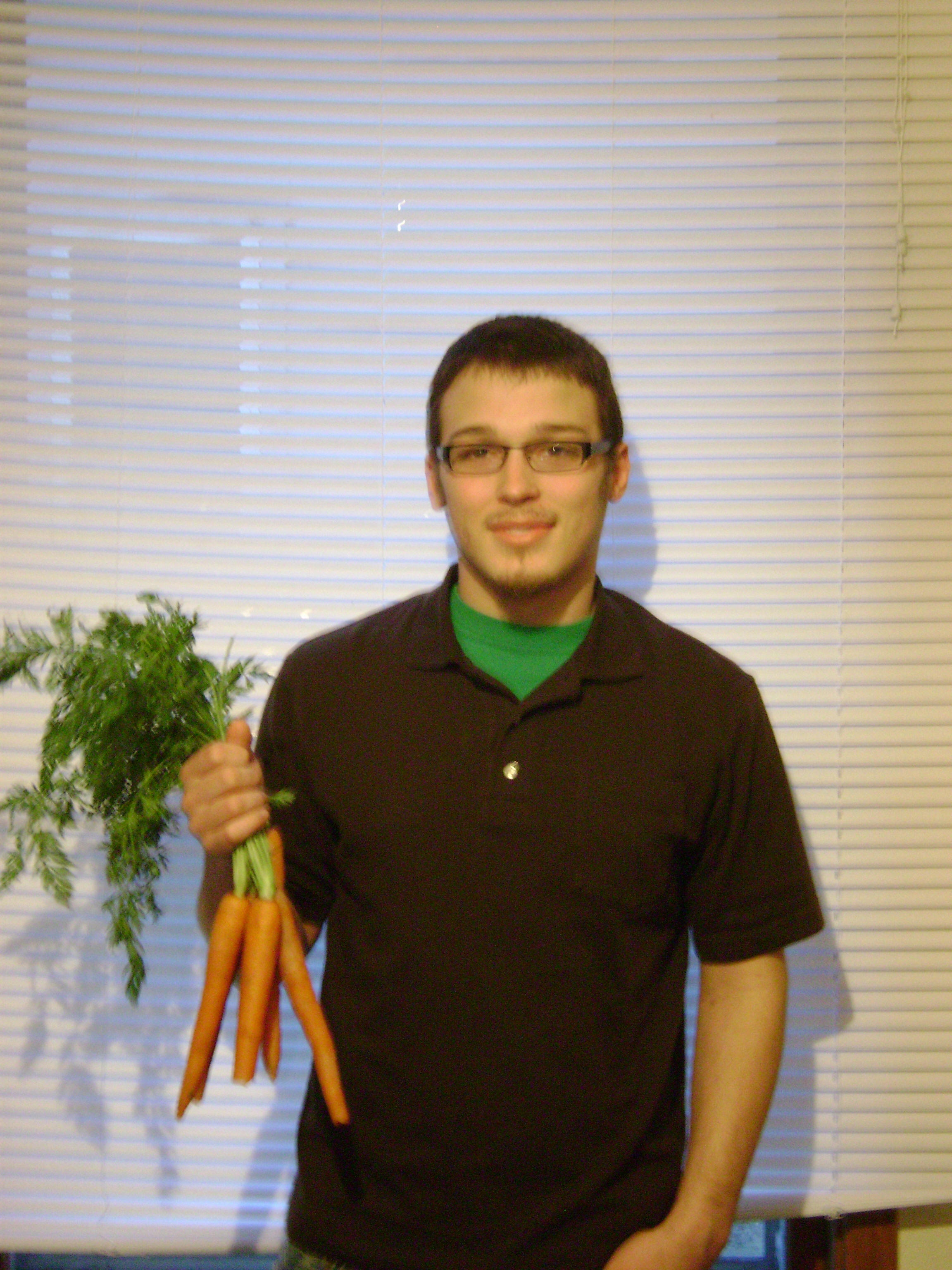 Peter Hordyk holding carrots taken by Ryan Cashman